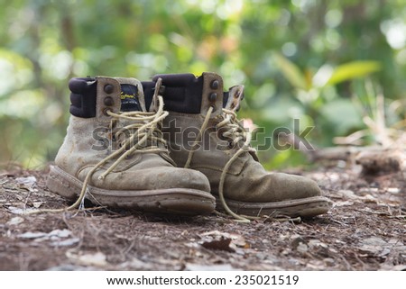 touristic boots near a camp