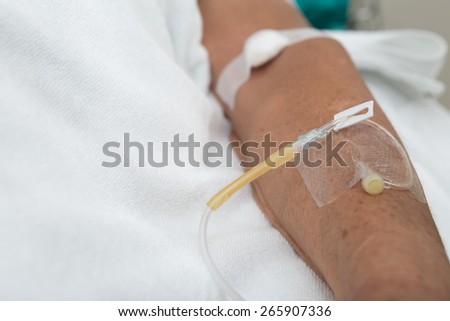 Left hand of the patient on clean bed in the hospital