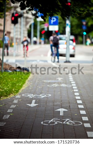 White bicycle on cycle way. Bike lane signal on the street.