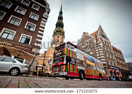 RIGA, LATVIA - JULY 25: Riga City Sightseeing tour bus on July 25, 2012 in Riga, Latvia. City Sightseeing operates in 100 cities worldwide and carries 8 million passengers per year.