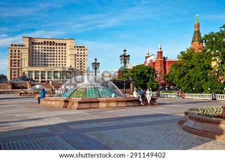 MOSCOW, RUSSIA - JUN 02,  2015: People relaxing on Manezh Square with view on Historic Museum and new hotel Four Seasons on June 02, 2015 in Moscow, Russia.