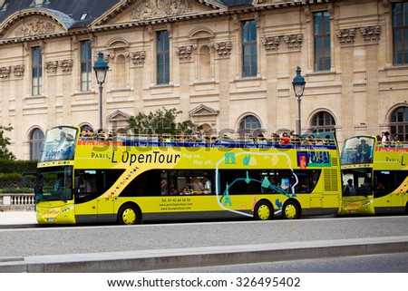 PARIS, FRANCE - AUGUST 27, 2011: Yellow city sightseeing bus Neoplan on Paris city street.