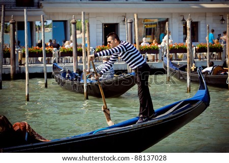 VENICE,ITALY - MAY 05: Gondoliers navigate on the Venice canals morning on May 5, 2011 in Venice, Italy. The gondola is a traditional, flat-bottomed Venetian rowing boat.