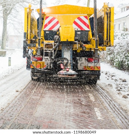 Winter service truck or spreading salt and sand on the road surface to prevent icing