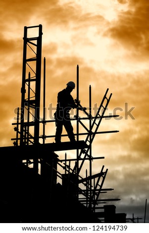 builder silhouette of construction worker on scaffold