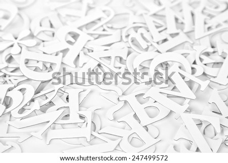 White Latin Letters on a white background. Selective focus. High key