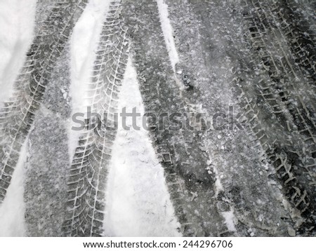 Tire tracks - tire marks in the light snow in winter.