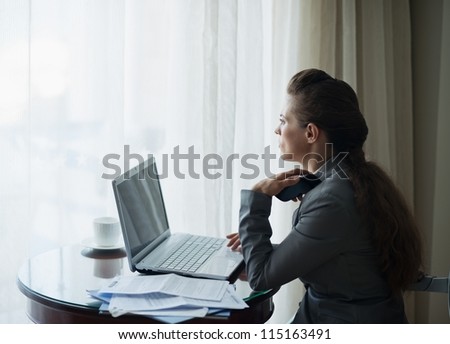 Thoughtful business woman working at hotel room