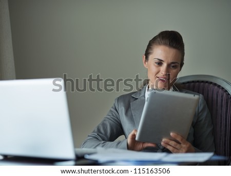 Business woman working with tablet PC in hotel room