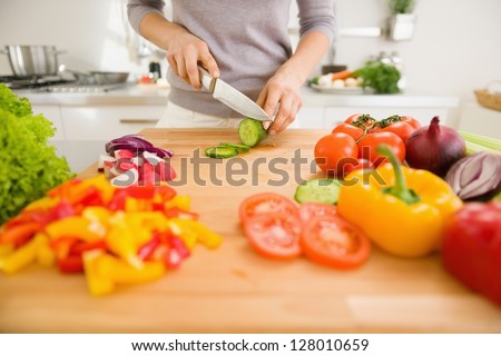 Closeup On Young Woman Slicing Vegetables