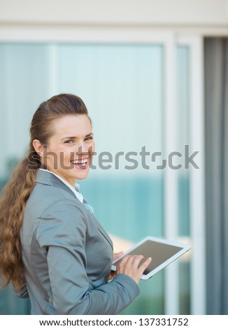 Happy business woman with tablet pc on terrace