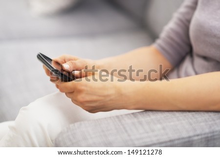 Closeup on pills pack in hand of ill young woman laying on sofa