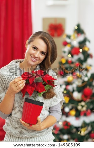 Portrait of happy young woman with christmas rose