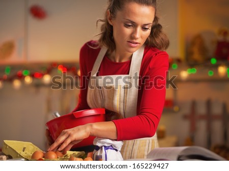 Young Housewife Preparing Christmas Dinner In Kitchen