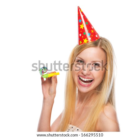 Portrait of smiling teenage girl in cap party horn blower