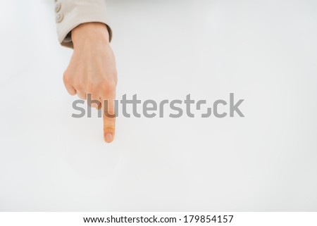 Closeup on business woman pointing on desk