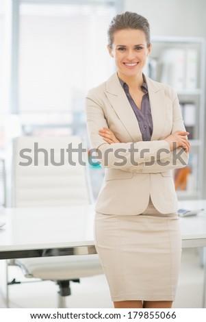 Portrait of smiling business woman standing in office