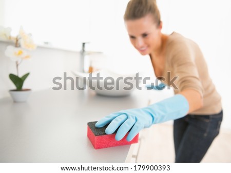 Closeup on young woman cleaning desk in bathroom