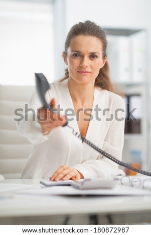 Modern business woman giving phone