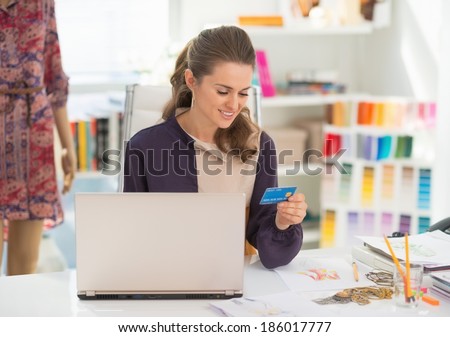 Happy fashion designer making online shopping