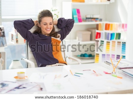Portrait of relaxed fashion designer in office