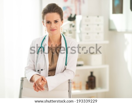 Portrait of happy medical doctor woman in office