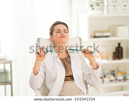 Relaxed medical doctor woman sitting in office