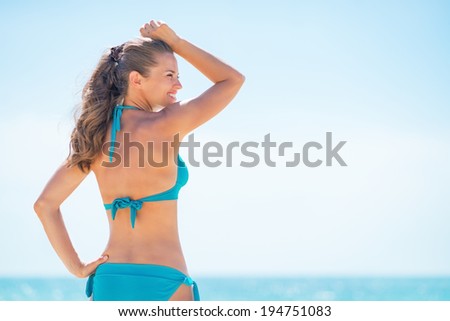 Portrait of young woman on beach looking into distance
