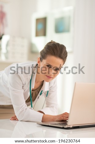 Portrait of medical doctor woman working on laptop in office