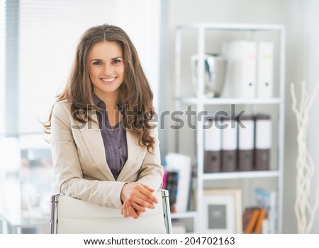 Portrait of happy business woman standing in office