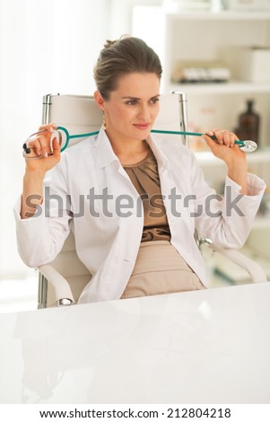 Portrait of relaxed doctor woman in office