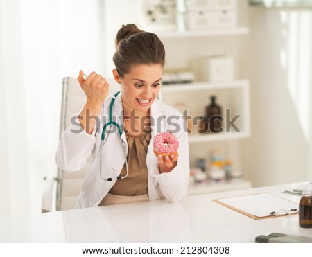 Angry doctor woman making injection into donut