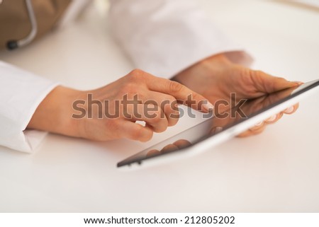 Closeup on doctor woman using tablet pc