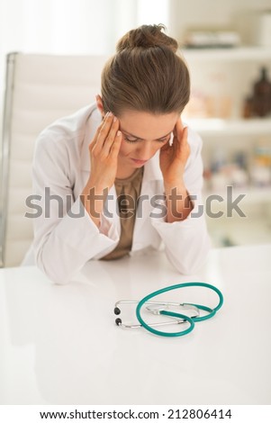 Portrait of stressed doctor woman in office