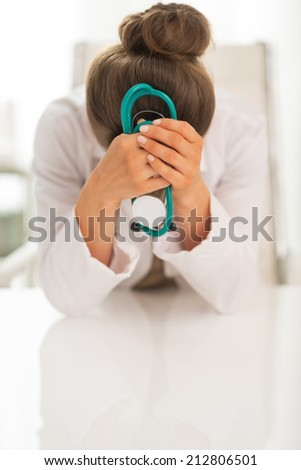 Portrait of stressed doctor woman