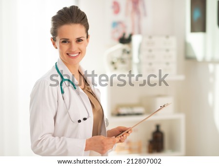 Portrait of doctor woman with clipboard in office