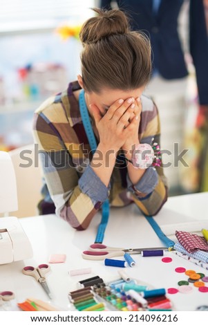 Portrait of stressed tailor woman at work