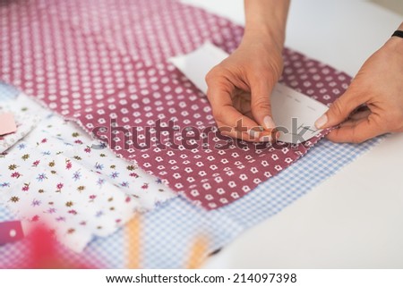 Closeup on tailor woman working with fabric