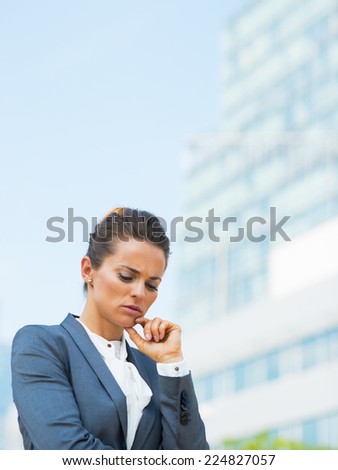 Portrait of stressed business woman in office district