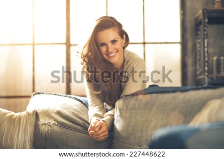 Portrait of happy young woman in loft apartment