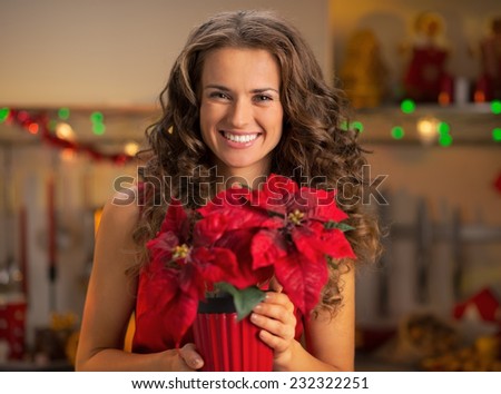 Portrait of happy young woman with christmas rose