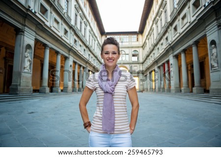 Portrait of smiling young woman near uffizi gallery in florence, italy