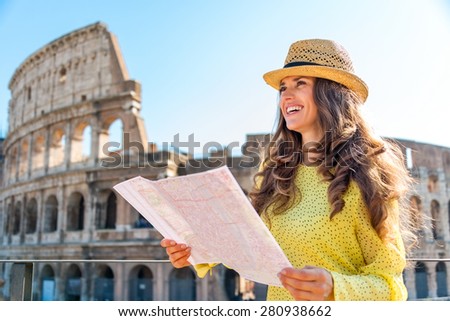 On a hot summer\'s day, a woman is standing holding a map of Rome and looking into the distance. In the background, the Rome Colosseum.