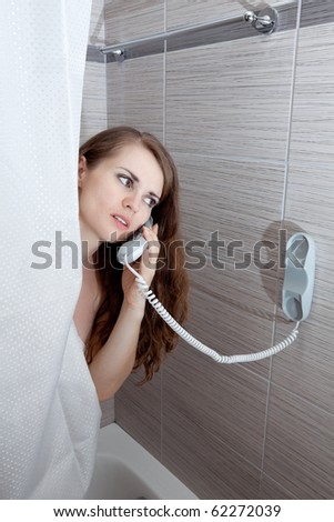 woman behind curtain making a call at bathroom