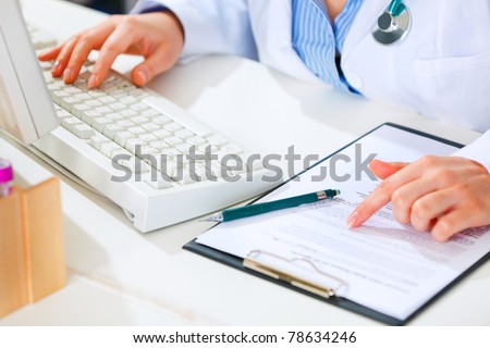 Medical doctor woman working at office table. Closeup.