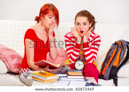 Two studying girlfriends shocked because running out of time at living room