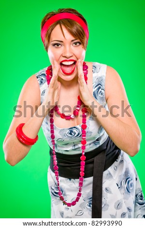 Cheerful girl fun shouting through megaphone shaped hands. Pin up and retro style .