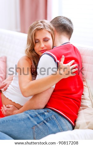 Beautiful pregnant woman hugging her husband