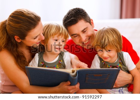 Family looking photo album