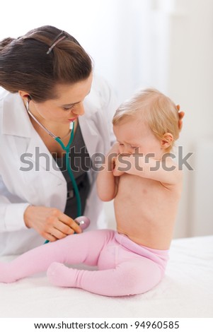 Pediatrician doctor calming crying baby